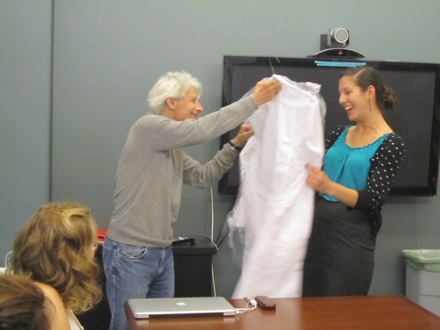 Dr. Goldberg presents a white coat to Krista at Final Symposium.